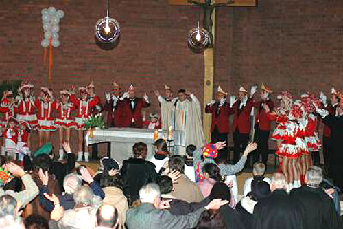 Majorettes and parishioners waving their arms during mass